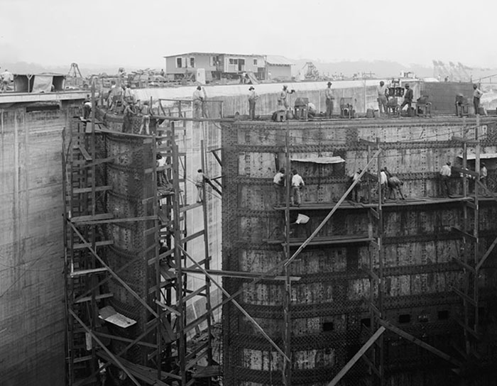 "Workers on scaffolding during the construction of an iconic place, showcasing intricate engineering details."