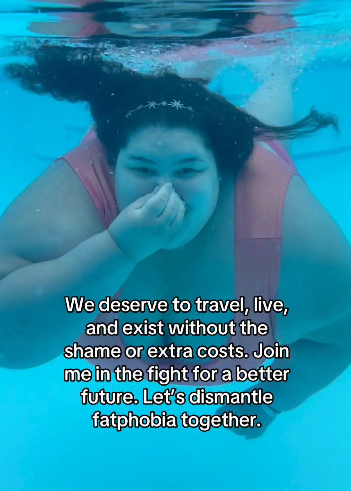 Plus-size woman swimming underwater, challenging fatphobia and advocating against extra costs for travel.