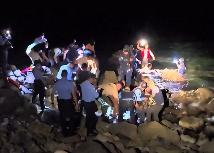 Rescue team responds at plane crash site near remote island at night.