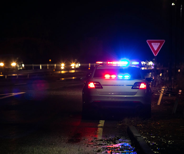 Police car with flashing lights at night, related to Kansas trooper rescuing kidnapped girl. Police car with flashing lights at night, related to Kansas trooper rescuing kidnapped girl.