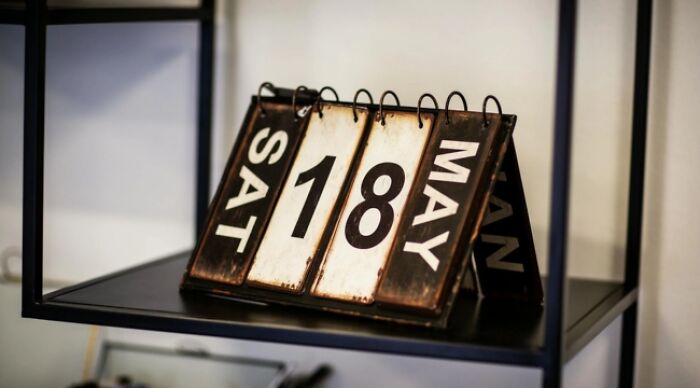 Retro calendar displaying Saturday, May 18th, highlighting a decision point in a 'Would You Rather' game.