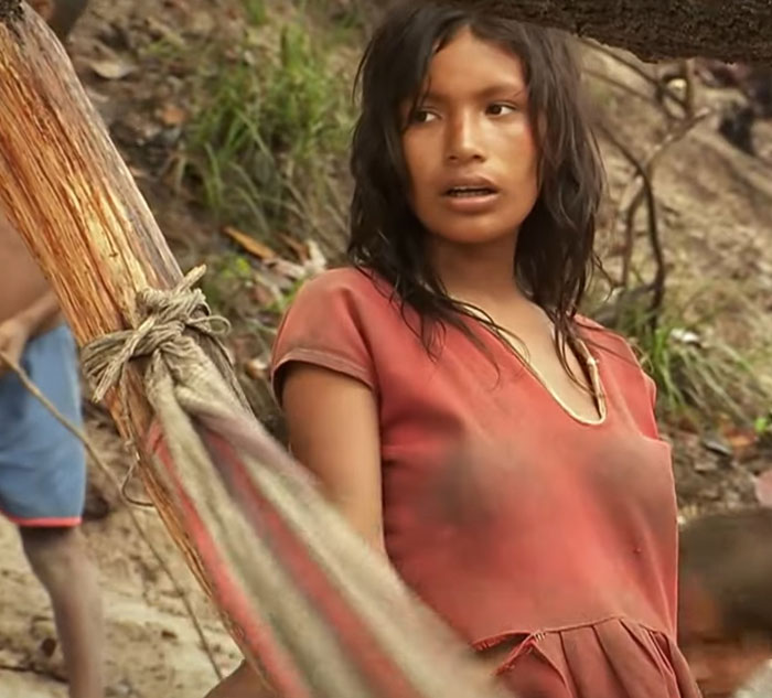 Young woman in a red dress standing outdoors, offering an opportunity to learn something new about diverse cultures.