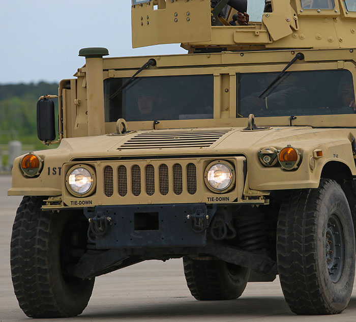 Tan military vehicle on a road, highlighting fascinating facts about its design and function.