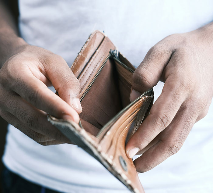 Person holding an empty wallet, offering an opportunity to learn new personal finance insights.