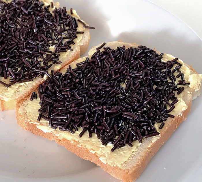Bread slices topped with butter and chocolate sprinkles, showcasing an opportunity to learn new culinary facts.