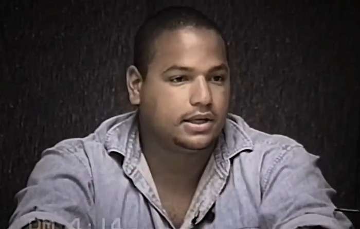 A man in a denim shirt speaks seriously, linked to claims about O.J. Simpson's son being the real culprit.
