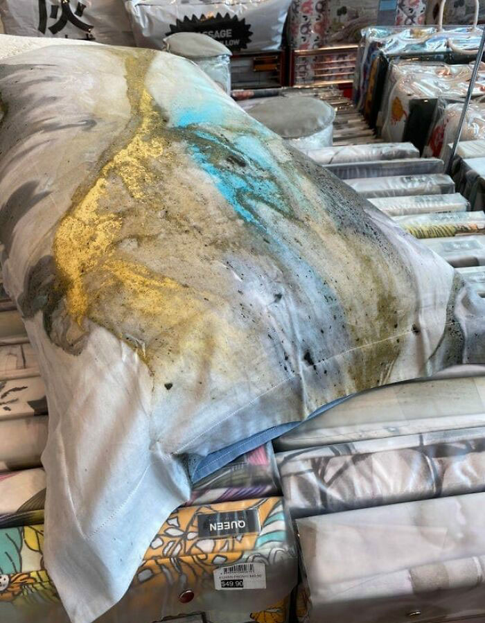 Design fails: Pillow with an abstract, unfinished print on display in a store, highlighting a quality control issue.