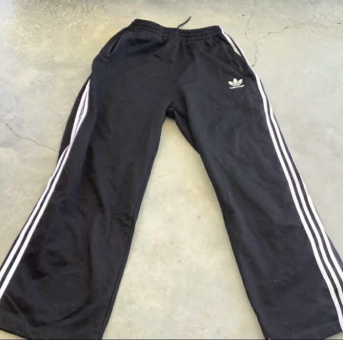 Black track pants on a concrete floor, illustrating alternate product use.