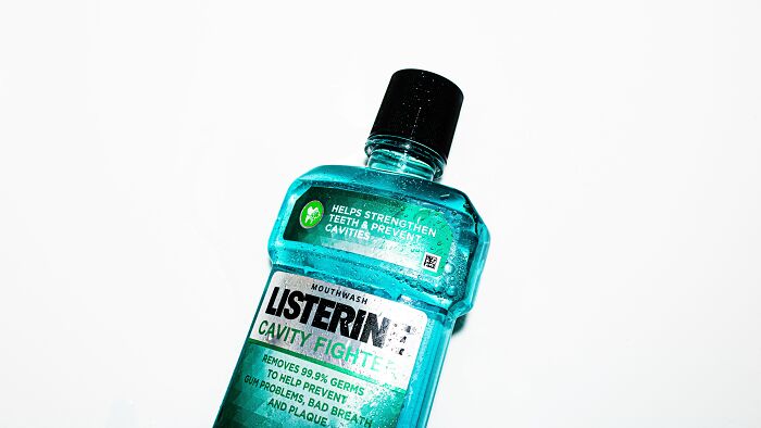 Listerine mouthwash bottle on a white background, used for different purpose than intended.