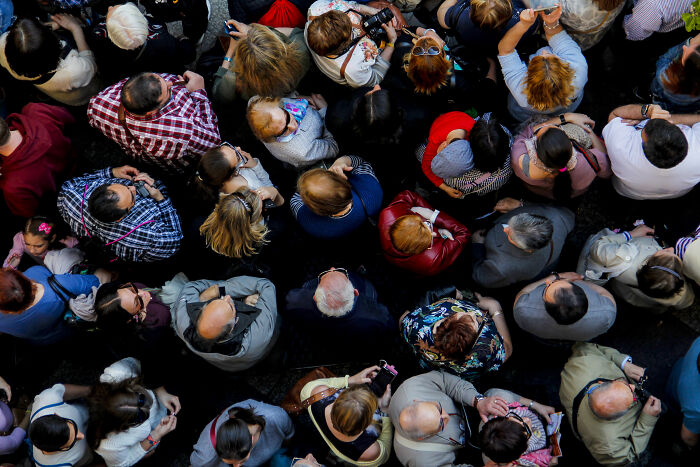 Aerial view of a crowded gathering, highlighting diverse individuals in an urban setting.