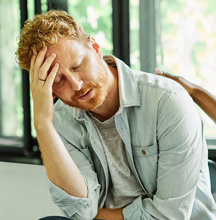 Man stressed, hand on forehead, after MIL demands payment for her hospital bill due to gift incident. Man stressed, hand on forehead, after MIL demands payment for her hospital bill due to gift incident.