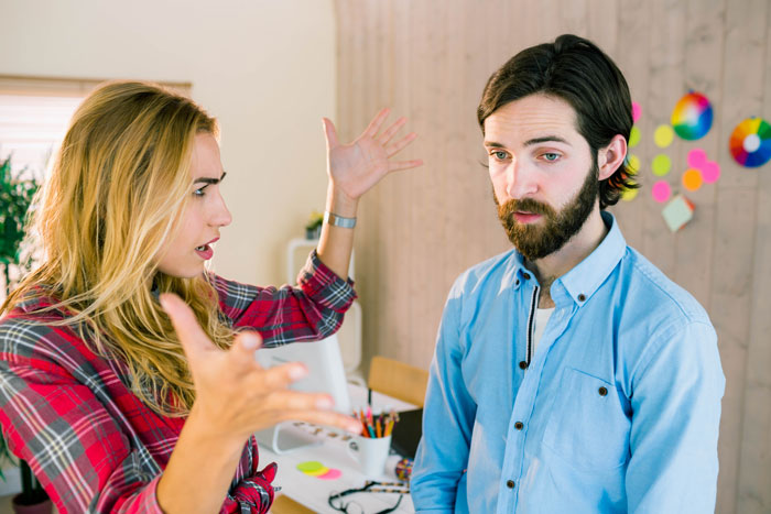 Woman reporting coworker's cheating in a walking competition, gesturing emotionally in an office setting. Woman reporting coworker's cheating in a walking competition, gesturing emotionally in an office setting.