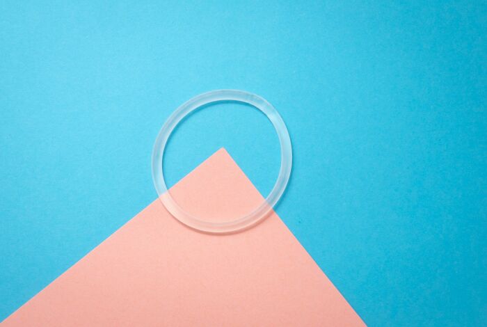 Transparent ring on blue and pink background, representing weird things doctors removed from bodies.
