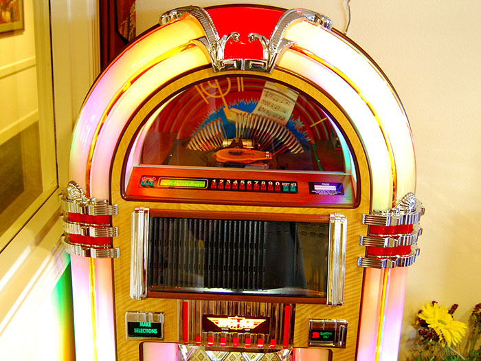 Retro jukebox from a nostalgic restaurant, surrounded by colorful lights and vintage decor.
