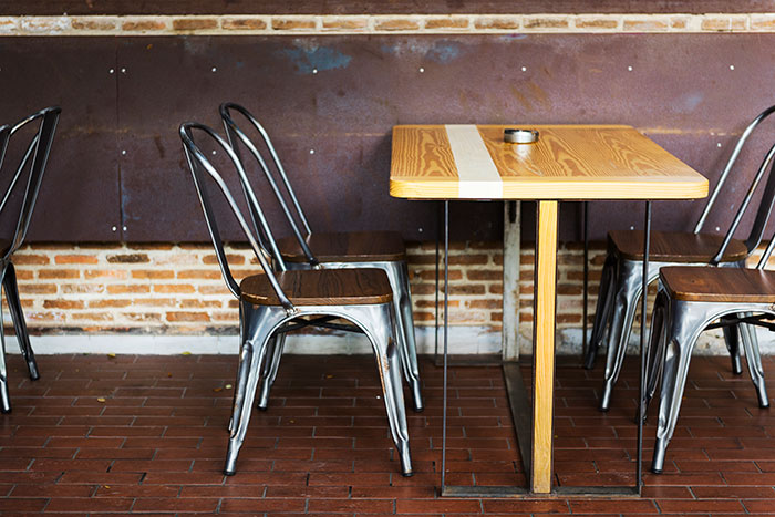 Empty table and chairs in a vintage restaurant setting, evoking memories of restaurants that don't exist today.
