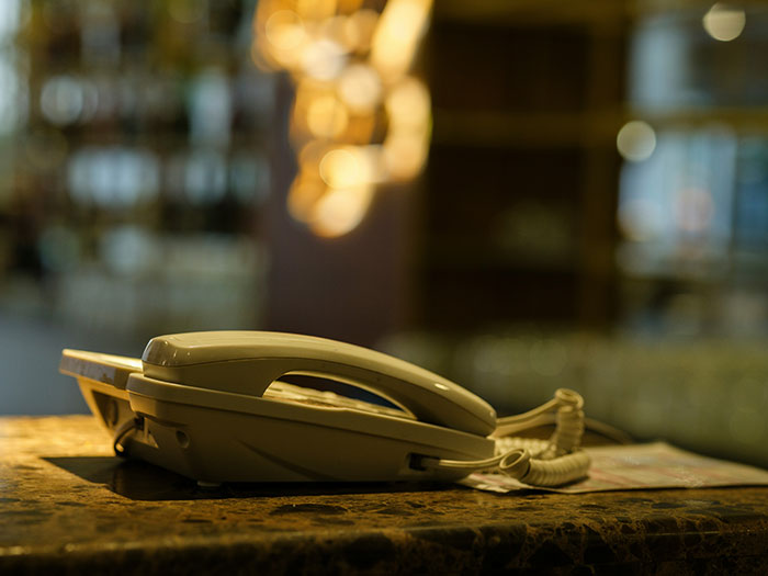 Retro telephone on a restaurant counter, symbolizing memories from restaurants that don't exist today.