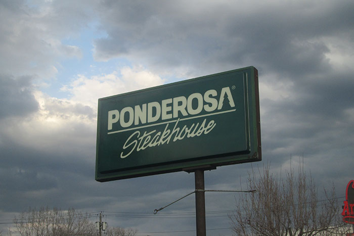 Ponderosa Steakhouse sign under cloudy sky; a nostalgic reminder of restaurants that don't exist today.