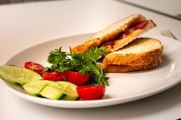 Sandwich with tomatoes and cucumber slices, reminiscent of former restaurant favorites.