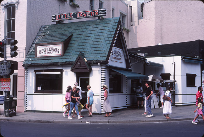 People walking past Little Tavern, a nostalgic restaurant that no longer exists today.