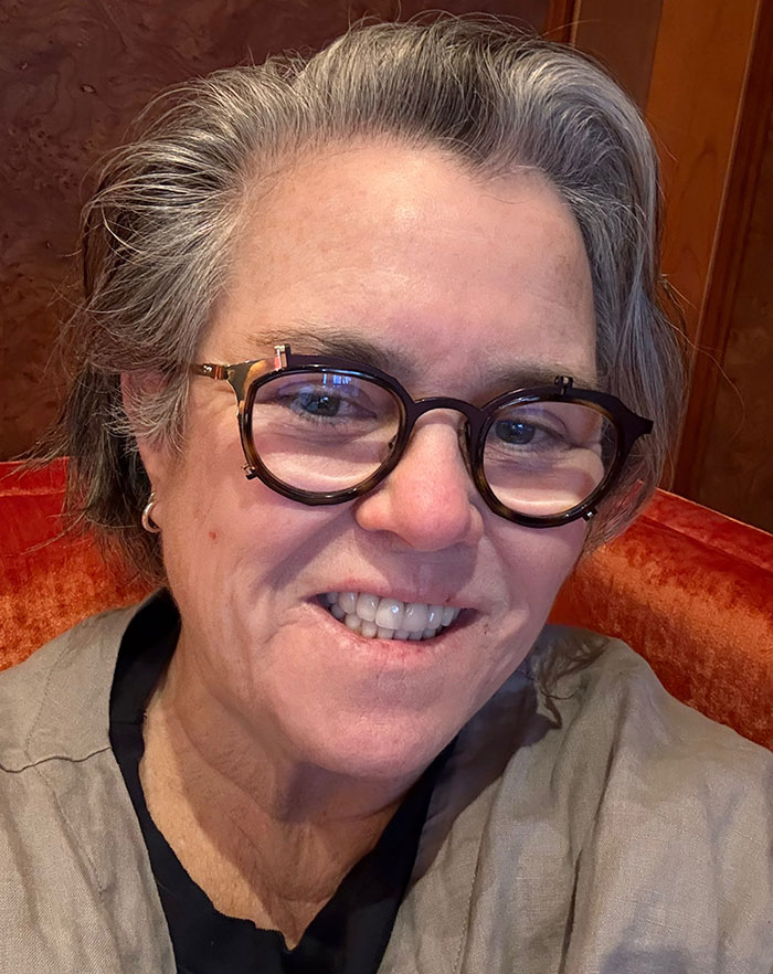 Person wearing glasses and smiling, associated with move to Ireland.