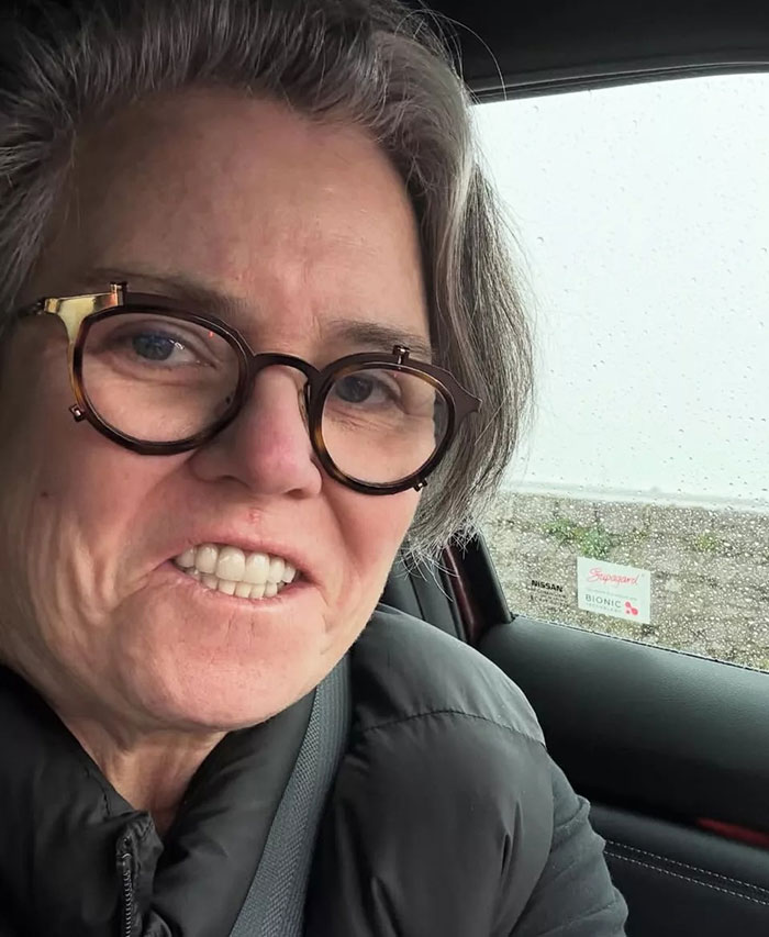 Person with glasses in a car, snowy background visible through the window, related to move to Ireland.