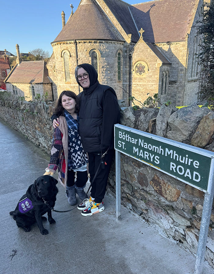 Woman and child with dog on St. Mary&rsquo;s Road, Ireland.
