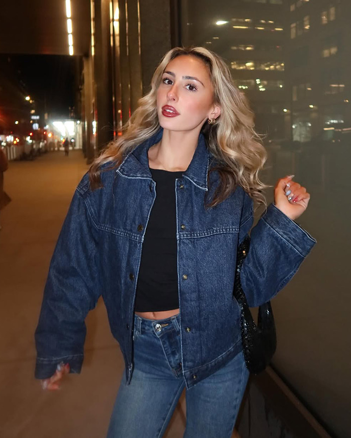 Person in denim jacket and jeans posing on city street at night, related to Photoshop fail discussion.