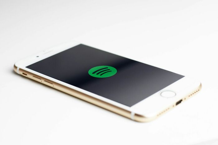 Smartphone displaying Spotify app logo on screen.