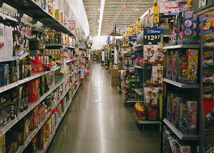A deserted grocery aisle evokes a chilling need to leave immediately, with shelves stocked and prices visible above.