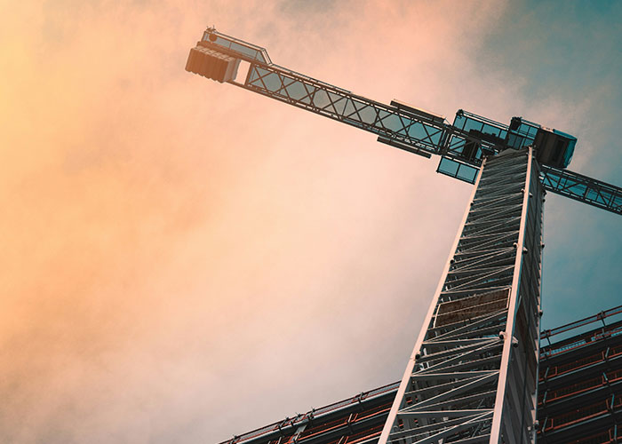 Construction crane against a dramatic sky, symbolizing intense "I need to leave now" experiences.