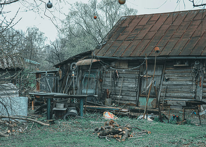 Old abandoned cabin in the woods, evoking a need to leave due to its eerie and unsettling atmosphere.