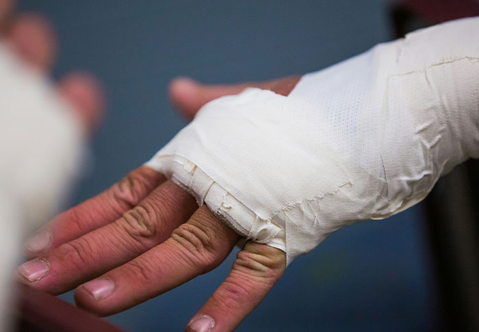 Close-up of a hand with bandaged fingers, conveying a sense of disturbing facts.