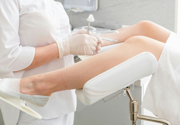 Doctor in white coat preparing for a medical exam.