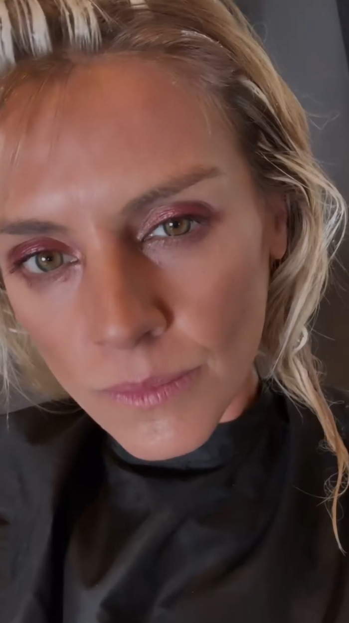 Blonde woman with wet hair and subtle makeup, addressing trolls post-premiere.