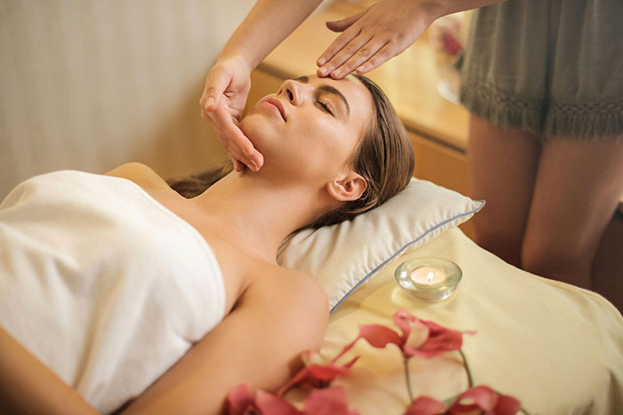 Woman enjoying relaxing massage, highlighting need for alone time and personal space.