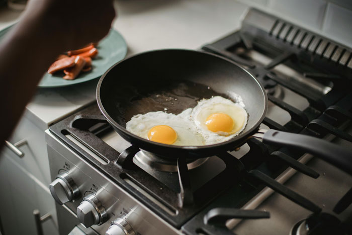 Eggs cooking in a skillet on a stove, illustrating the concept of a stolen skillet in use.