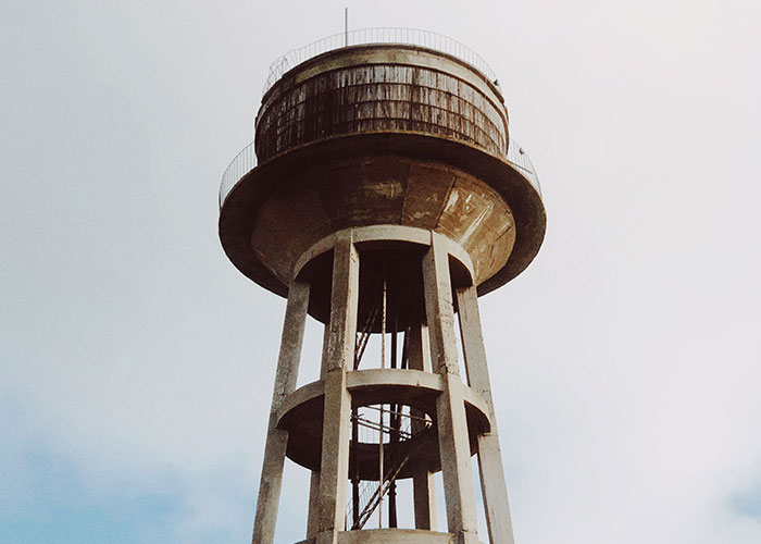 Old water tower symbolizing small town incidents left unspoken.