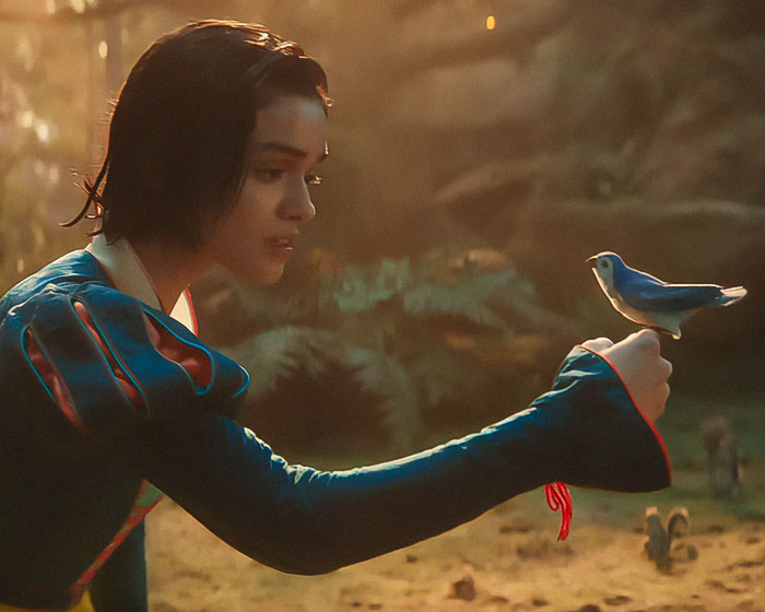 Snow White from Disney's film reaching out to a bluebird, set in a forest scene. Snow White from Disney's film reaching out to a bluebird, set in a forest scene.