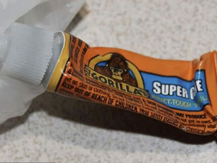 Gorilla super glue tube on a table, related to coworker spiking Coke with unusual items. Gorilla super glue tube on a table, related to coworker spiking Coke with unusual items.