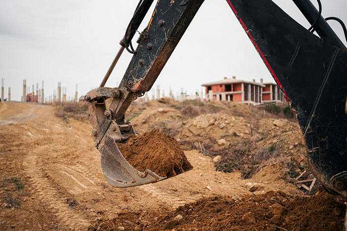 Excavator digging on a construction site, showcasing split-second decisions in safety and efficiency.