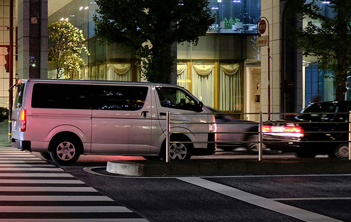 White van at a city intersection at night, highlighting life-saving decisions in urban environments.