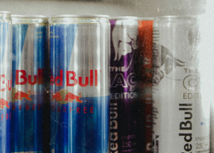 Cans of Red Bull energy drinks in a fridge, related to wild reasons for lawsuits.