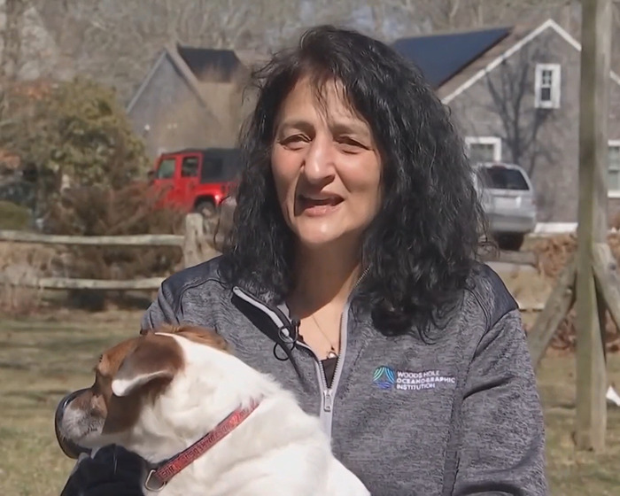 A woman outside with a dog, related to NASA astronaut's psychological trauma experience.