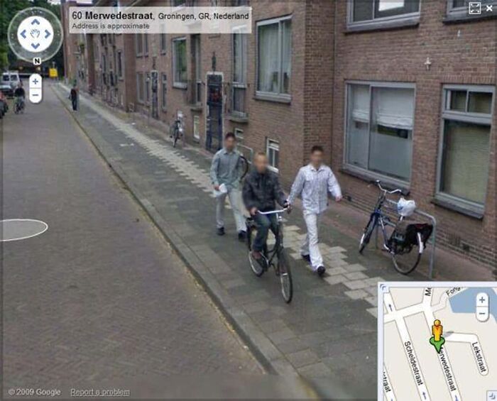 Strange scene captured on Google Earth: three blurred people walking and cycling on a street in Groningen, Netherlands.