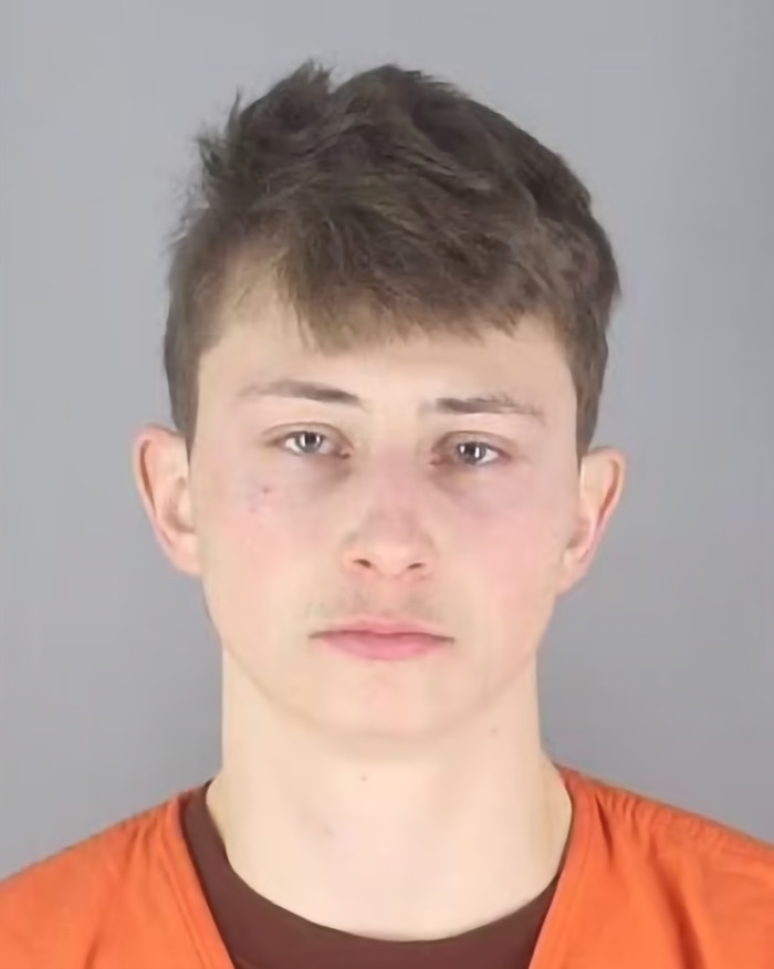 Conner Michael Iversen's mugshot wearing an orange outfit.