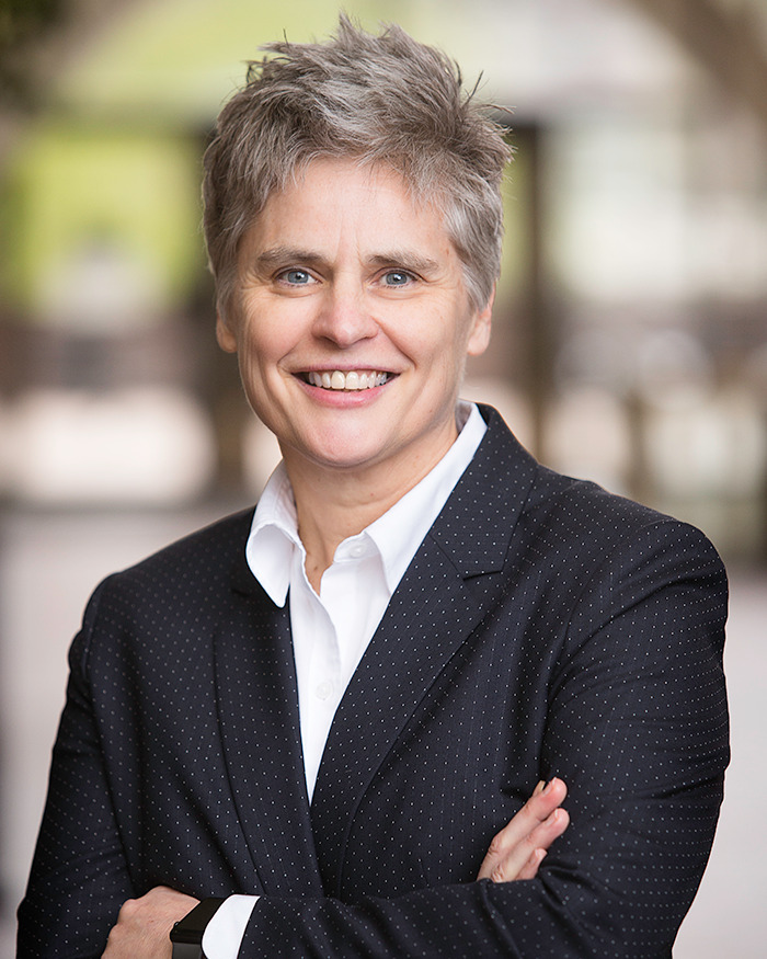 District Attorney Mary Moriarty in a suit, standing outdoors.