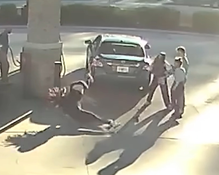 Girl body slams suspect at gas station during prom dress incident, with bystanders nearby.