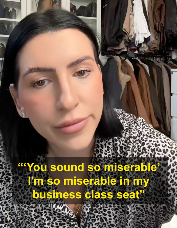 Millennial with child-free lifestyle faces backlash, wearing a leopard print shirt in a closet.