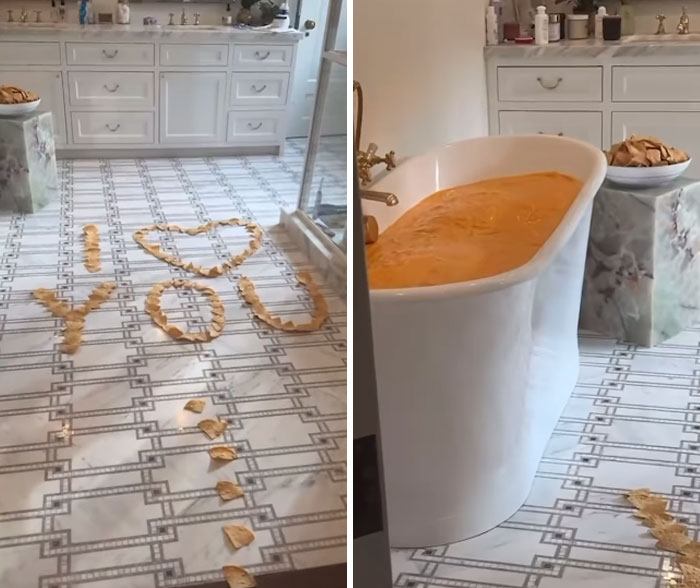 Bathtub filled with orange liquid, chips on floor spelling "I ❤ YOU," showcasing wasteful celebrity indulgence.