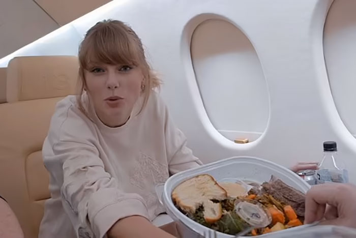 Celebrity on a private jet with an uneaten meal, highlighting wasteful behavior.